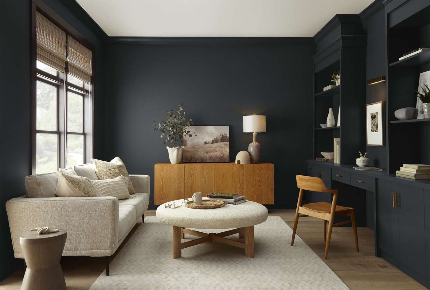 Living room painted in deep navy with built-in cabinetry