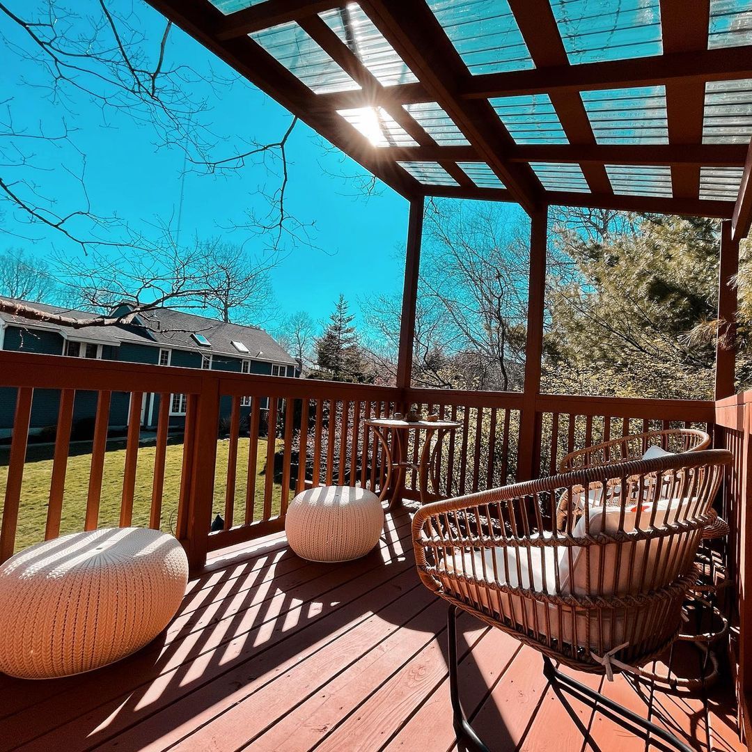 Stained deck with a pergola and outdoor seating