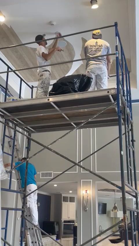 Rocha Pro Painters crew painting an exterior from scaffolding