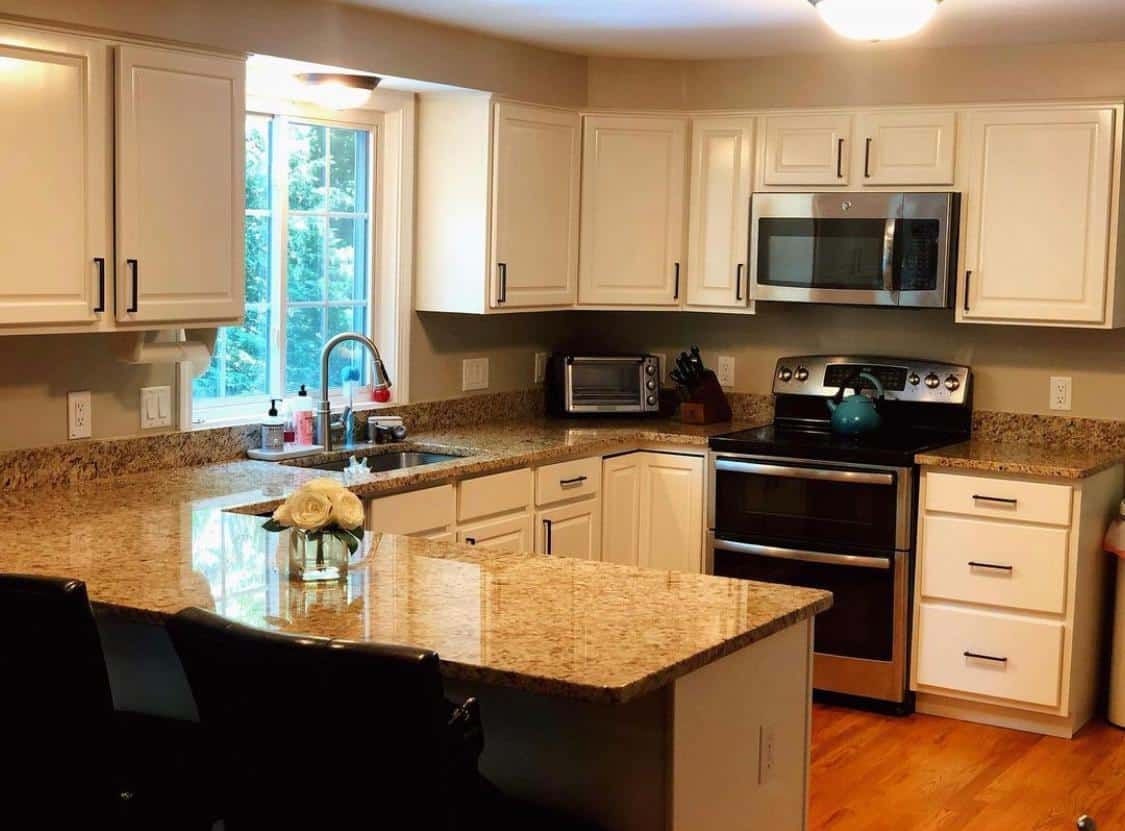 Kitchen with white painted cabinets and granite counters